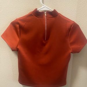Brownish/red high neck blouse; short and best worn with high waisted bottoms